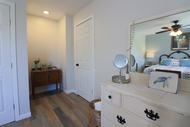 bedroom with baseboards and dark wood-style floors