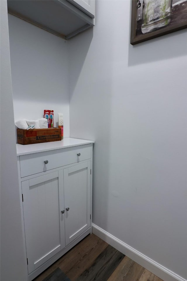 interior space with baseboards and dark wood-style floors