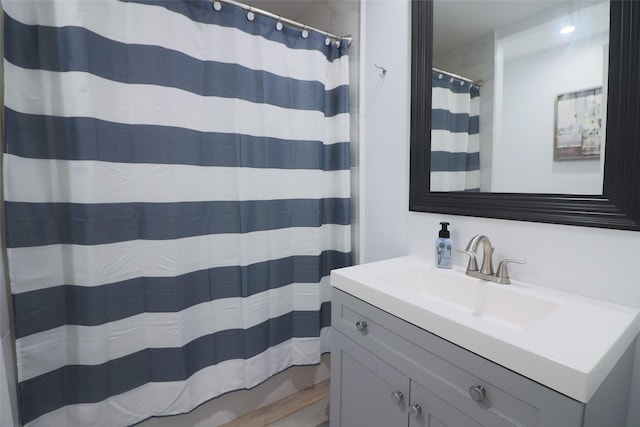 bathroom featuring vanity and curtained shower