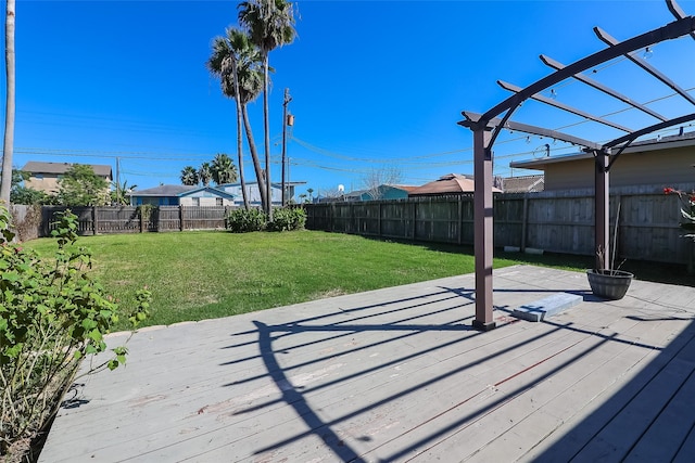 wooden deck featuring a lawn, a fenced backyard, and a pergola