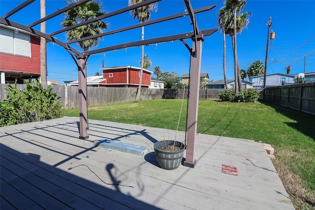 wooden terrace featuring a lawn, a fenced backyard, and a pergola