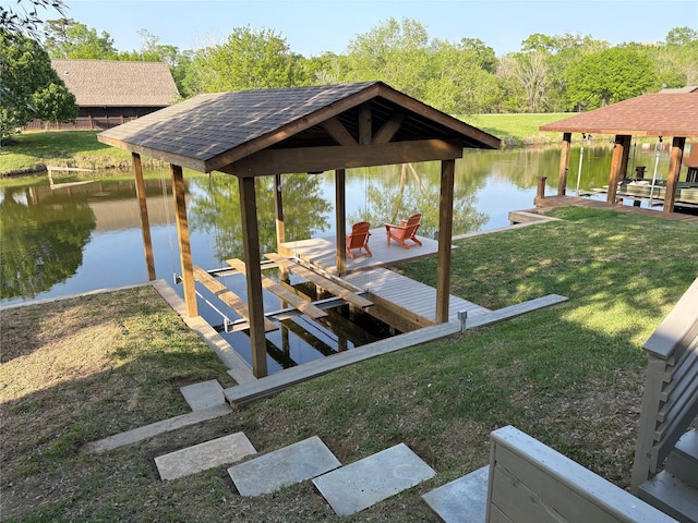 dock area featuring a lawn, a water view, a gazebo, and boat lift