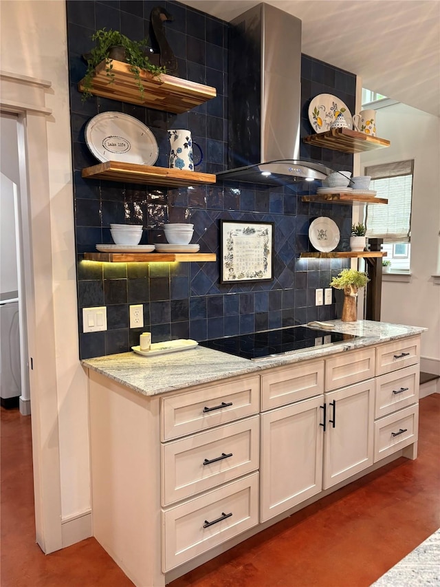 bar with baseboards, black electric stovetop, wall chimney range hood, and decorative backsplash