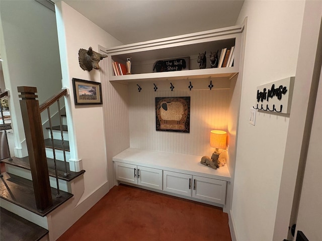 mudroom featuring dark colored carpet