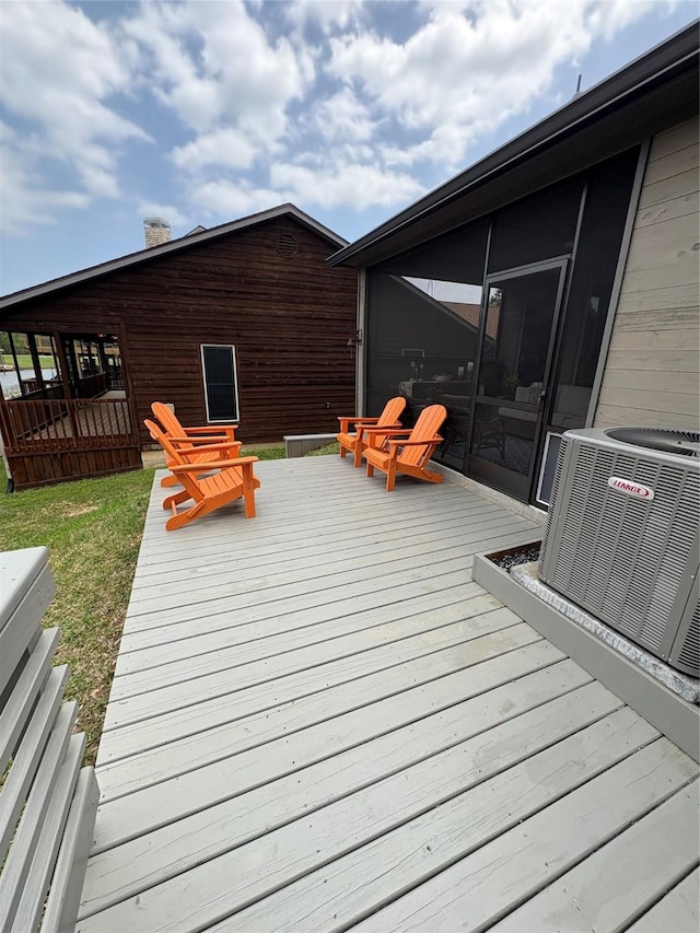 wooden terrace featuring central AC unit and a sunroom
