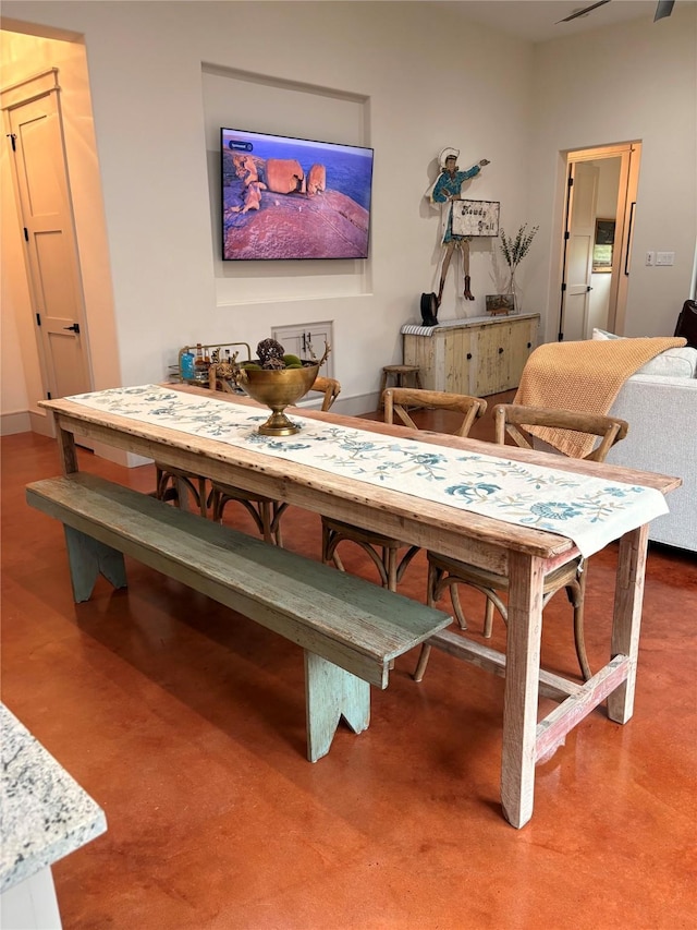 dining space featuring baseboards and concrete floors