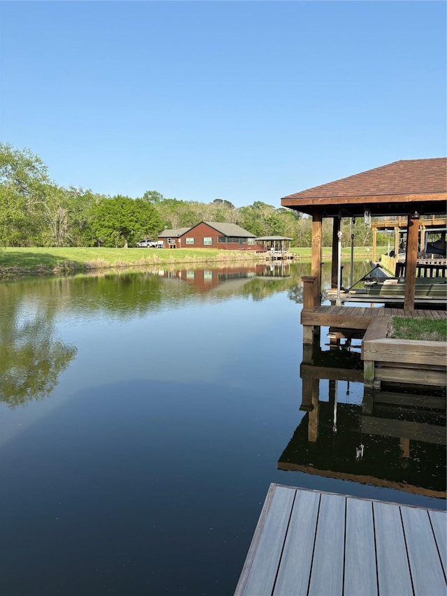 dock area with a water view and boat lift