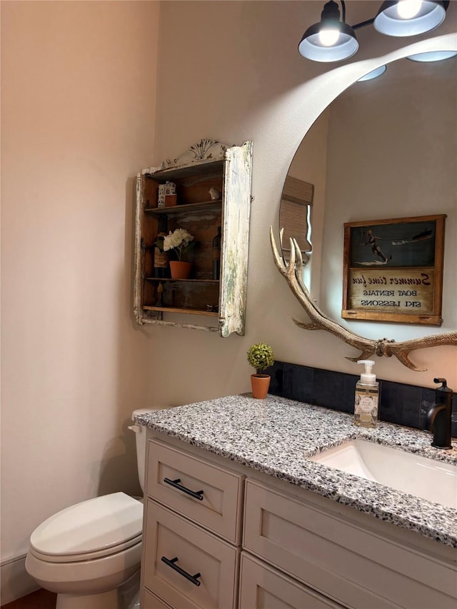 half bathroom with toilet and vanity