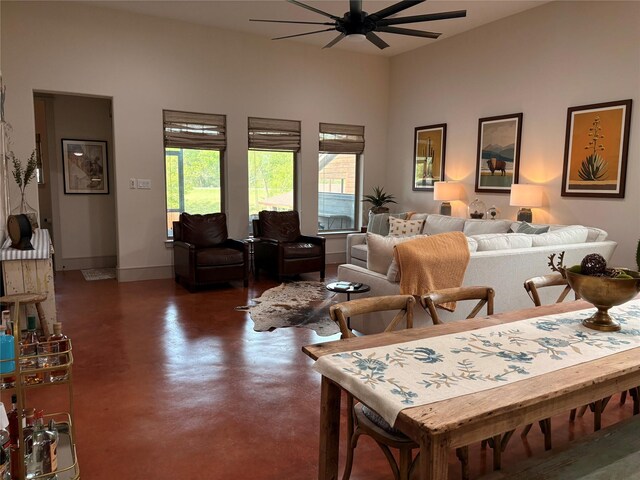 interior space with concrete floors, ceiling fan, and baseboards