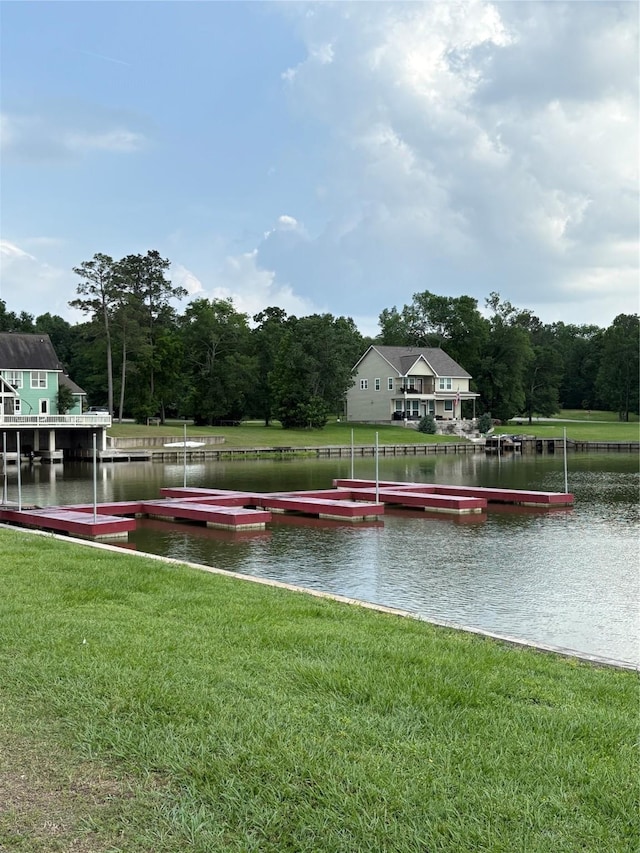 exterior space with a water view and a lawn