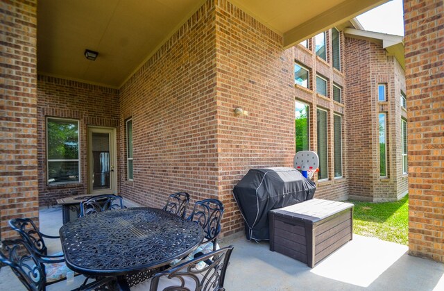 view of patio / terrace featuring area for grilling and outdoor dining area