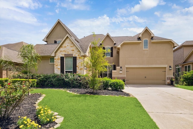 27 Tioga Pl, The Woodlands, TX 77375 - view of front facade featuring stucco siding, stone siding, driveway, a front lawn, and roof with shingles