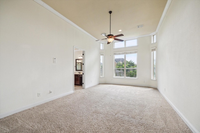 27 Tioga Pl, The Woodlands, TX 77375 - empty room featuring crown molding, a ceiling fan, light colored carpet, and baseboards