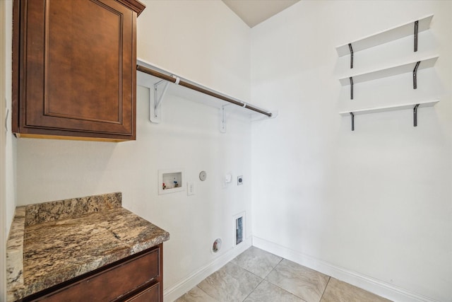 27 Tioga Pl, The Woodlands, TX 77375 - laundry room with hookup for a gas dryer, washer hookup, hookup for an electric dryer, baseboards, and cabinet space