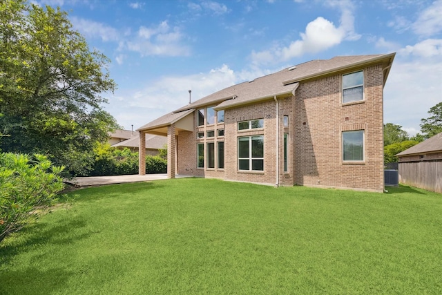 27 Tioga Pl, The Woodlands, TX 77375 - back of property with brick siding, central air condition unit, and roof with shingles