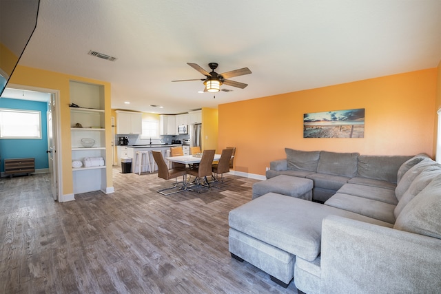4206 Seabird Dr, Galveston, TX 77554 - living area featuring ceiling fan and dark wood-style flooring