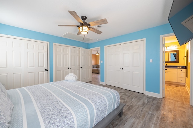 4206 Seabird Dr, Galveston, TX 77554 - bedroom with two closets, light wood-style floors, and a ceiling fan