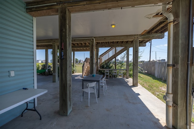 4206 Seabird Dr, Galveston, TX 77554 - view of patio / terrace with stairs and outdoor dining space