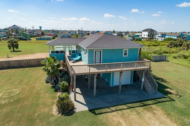 4206 Seabird Dr, Galveston, TX 77554 - back of house with a shingled roof, a deck, a carport, and a garage