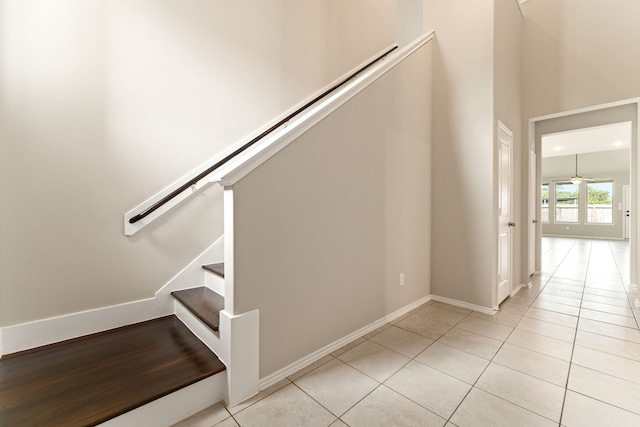 5014 Aspen Orchard Dr, Houston, TX 77066 - stairway featuring tile patterned flooring, baseboards, and a towering ceiling