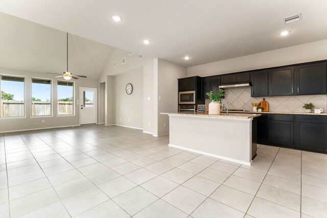 5014 Aspen Orchard Dr, Houston, TX 77066 - kitchen featuring appliances with stainless steel finishes, backsplash, light tile patterned floors, a ceiling fan, and lofted ceiling