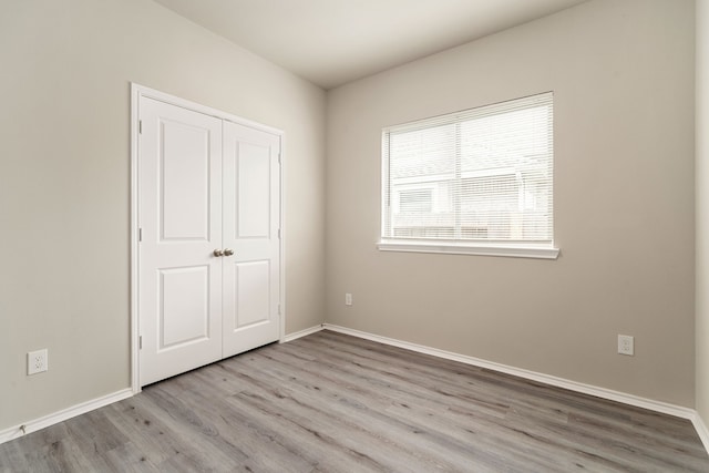 5014 Aspen Orchard Dr, Houston, TX 77066 - unfurnished bedroom with wood finished floors, baseboards, and a closet