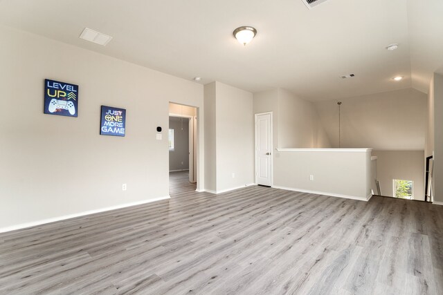5014 Aspen Orchard Dr, Houston, TX 77066 - empty room with wood finished floors, baseboards, and vaulted ceiling