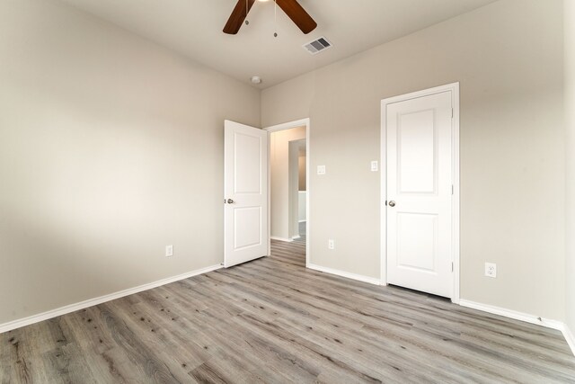 5014 Aspen Orchard Dr, Houston, TX 77066 - unfurnished bedroom featuring light wood-type flooring, baseboards, and a ceiling fan