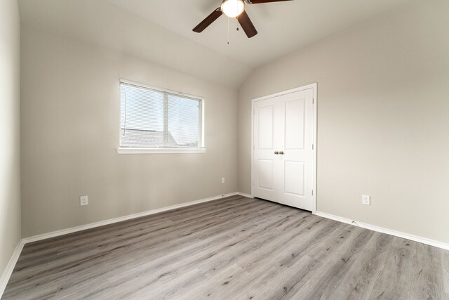 5014 Aspen Orchard Dr, Houston, TX 77066 - unfurnished bedroom with light wood-style flooring, lofted ceiling, baseboards, and a ceiling fan