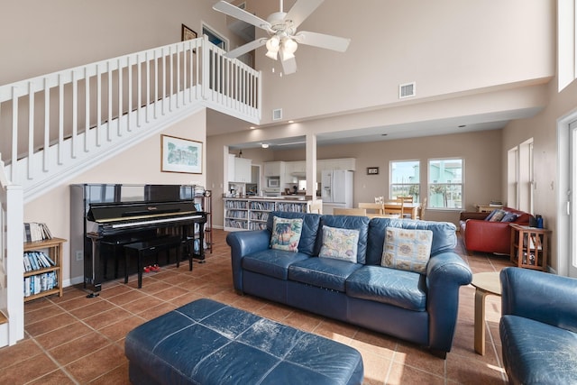 22915 Gulf Dr, Galveston, TX 77554 - tiled living room featuring a towering ceiling, visible vents, and ceiling fan