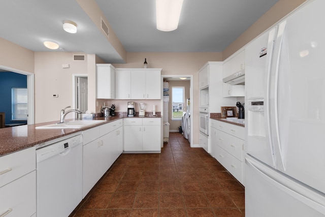 22915 Gulf Dr, Galveston, TX 77554 - kitchen with white cabinets, visible vents, white appliances, under cabinet range hood, and a sink