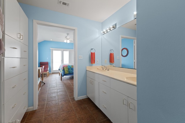 22915 Gulf Dr, Galveston, TX 77554 - ensuite bathroom with baseboards, visible vents, ensuite bath, ceiling fan, and double vanity