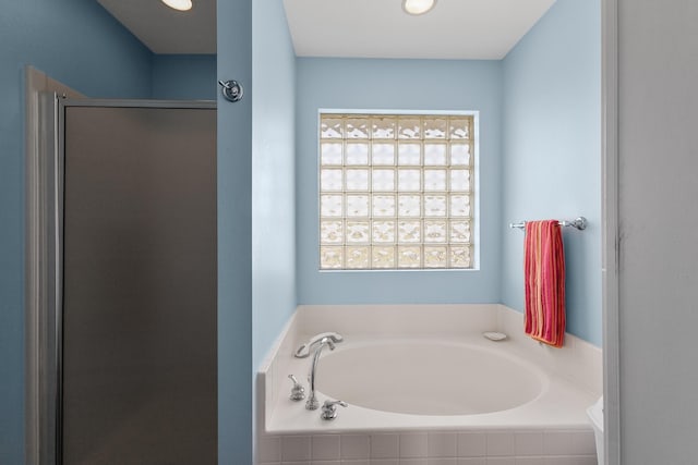 22915 Gulf Dr, Galveston, TX 77554 - full bathroom with a garden tub and a stall shower