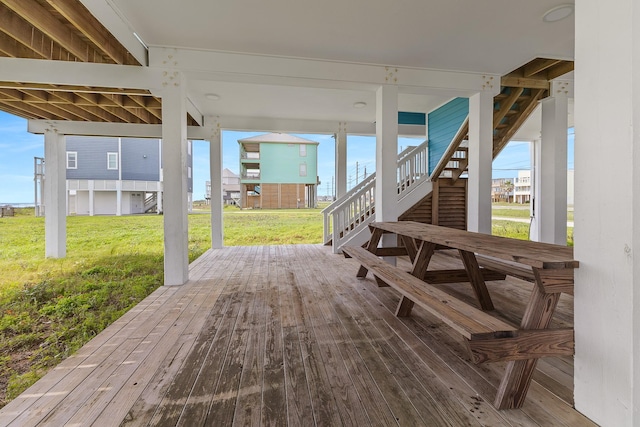 22915 Gulf Dr, Galveston, TX 77554 - wooden deck with stairway and a lawn