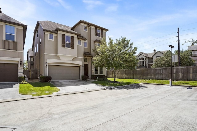 13217 Green Hills Dr, Houston, TX 77077 - view of front of house featuring stucco siding, an attached garage, and driveway