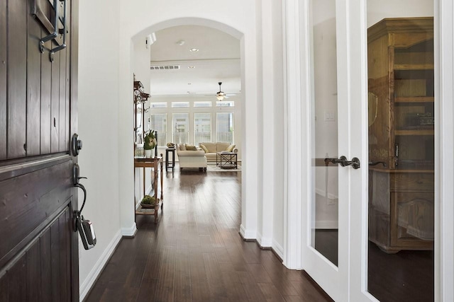 13217 Green Hills Dr, Houston, TX 77077 - foyer entrance featuring arched walkways, dark wood finished floors, baseboards, a ceiling fan, and recessed lighting