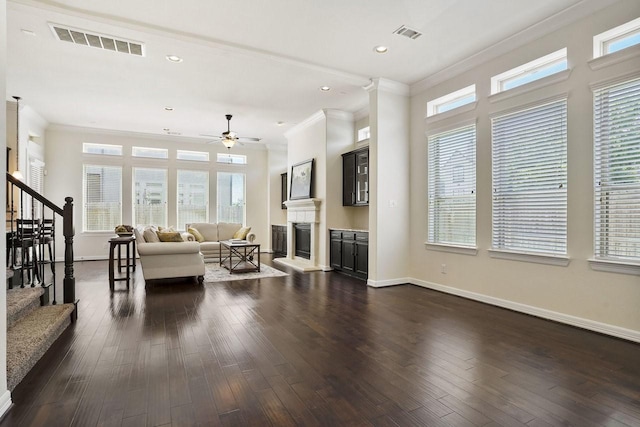 13217 Green Hills Dr, Houston, TX 77077 - living room featuring ornamental molding, healthy amount of natural light, a ceiling fan, stairway, and a glass covered fireplace