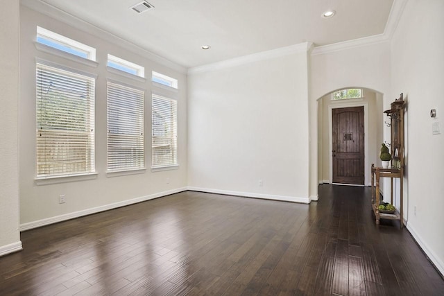 13217 Green Hills Dr, Houston, TX 77077 - spare room featuring ornamental molding, arched walkways, healthy amount of natural light, dark wood finished floors, and baseboards