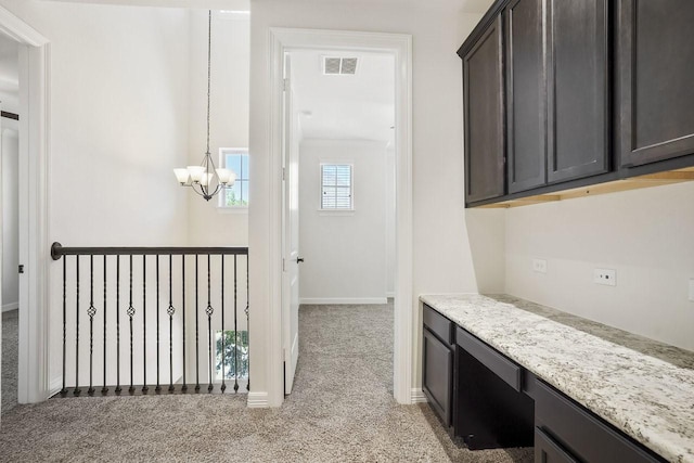 13217 Green Hills Dr, Houston, TX 77077 - hallway with light colored carpet, a chandelier, and baseboards