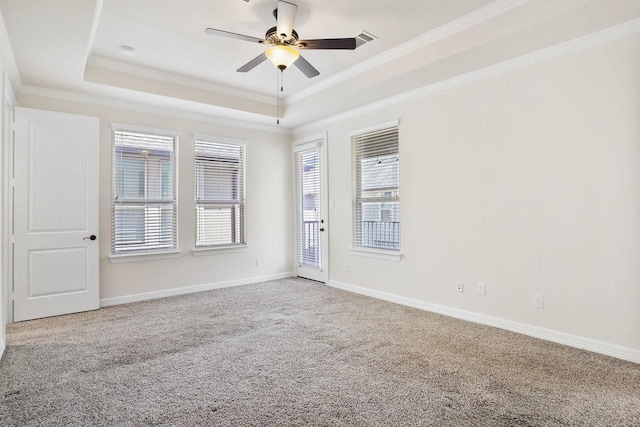 13217 Green Hills Dr, Houston, TX 77077 - spare room featuring a tray ceiling, carpet flooring, a ceiling fan, ornamental molding, and healthy amount of natural light