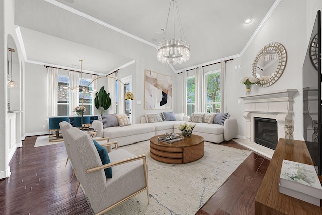 3411 Heather Garden Trl, Richmond, TX 77406 - living room with a chandelier, ornamental molding, hardwood / wood-style floors, a glass covered fireplace, and baseboards