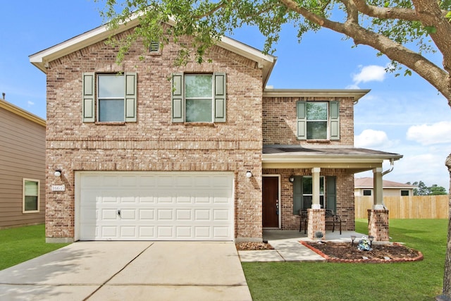 traditional home featuring brick siding, a front yard, fence, and concrete driveway