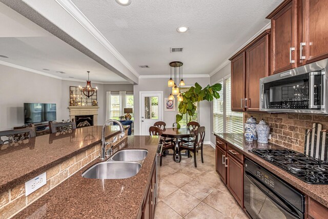 kitchen with black appliances, a sink, dark stone counters, decorative light fixtures, and tasteful backsplash
