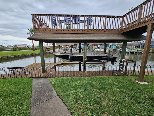 view of dock with a water view, a lawn, boat lift, and fence
