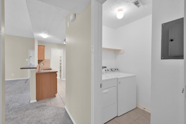 washroom featuring electric panel, a sink, light carpet, independent washer and dryer, and visible vents