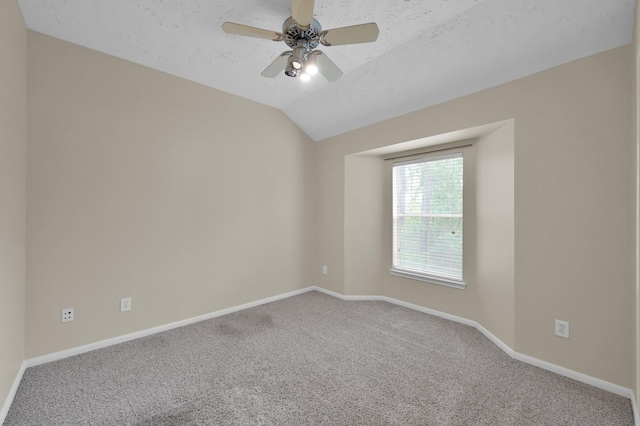 unfurnished room with a textured ceiling, baseboards, ceiling fan, carpet floors, and vaulted ceiling