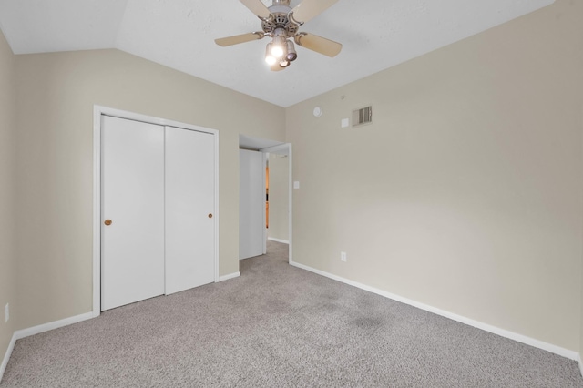 unfurnished bedroom with baseboards, carpet, a closet, and visible vents
