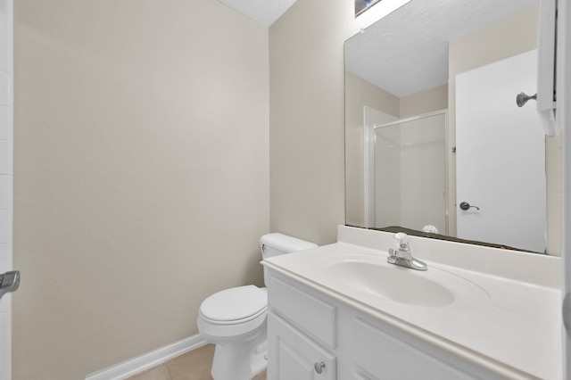 full bath featuring a shower stall, baseboards, toilet, vanity, and tile patterned flooring