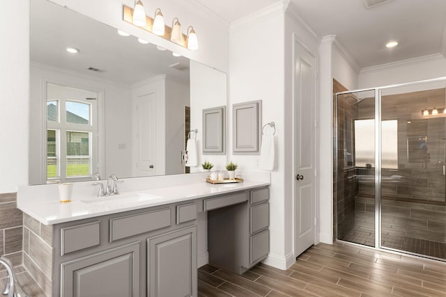 6518 Fairway Glen Ln, Katy, TX 77493 - full bathroom with visible vents, a stall shower, ornamental molding, wood finished floors, and vanity