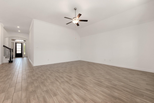 6518 Fairway Glen Ln, Katy, TX 77493 - unfurnished living room featuring ceiling fan, light wood-type flooring, baseboards, and arched walkways